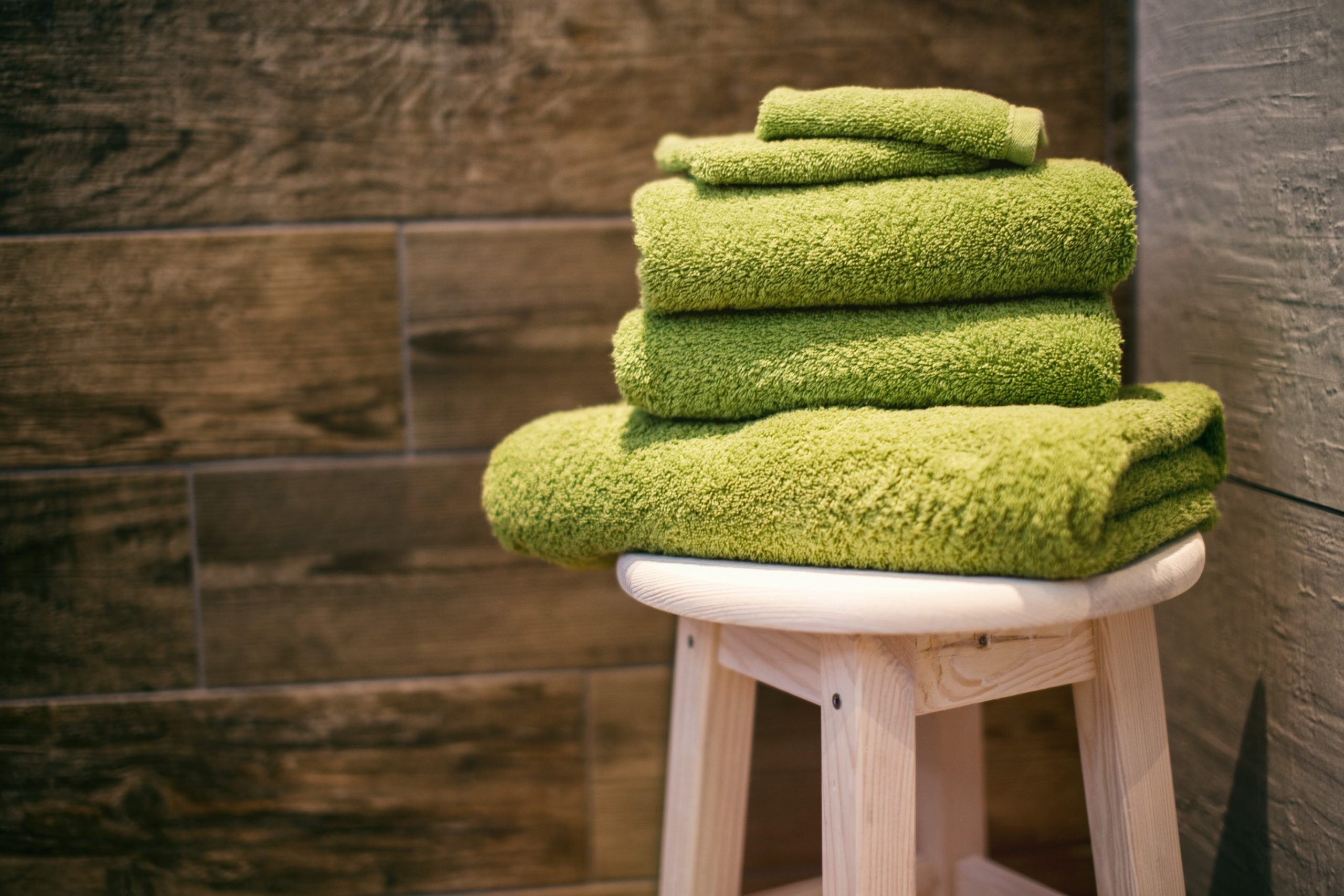 Stack of lime green towels in an infrared sauna.