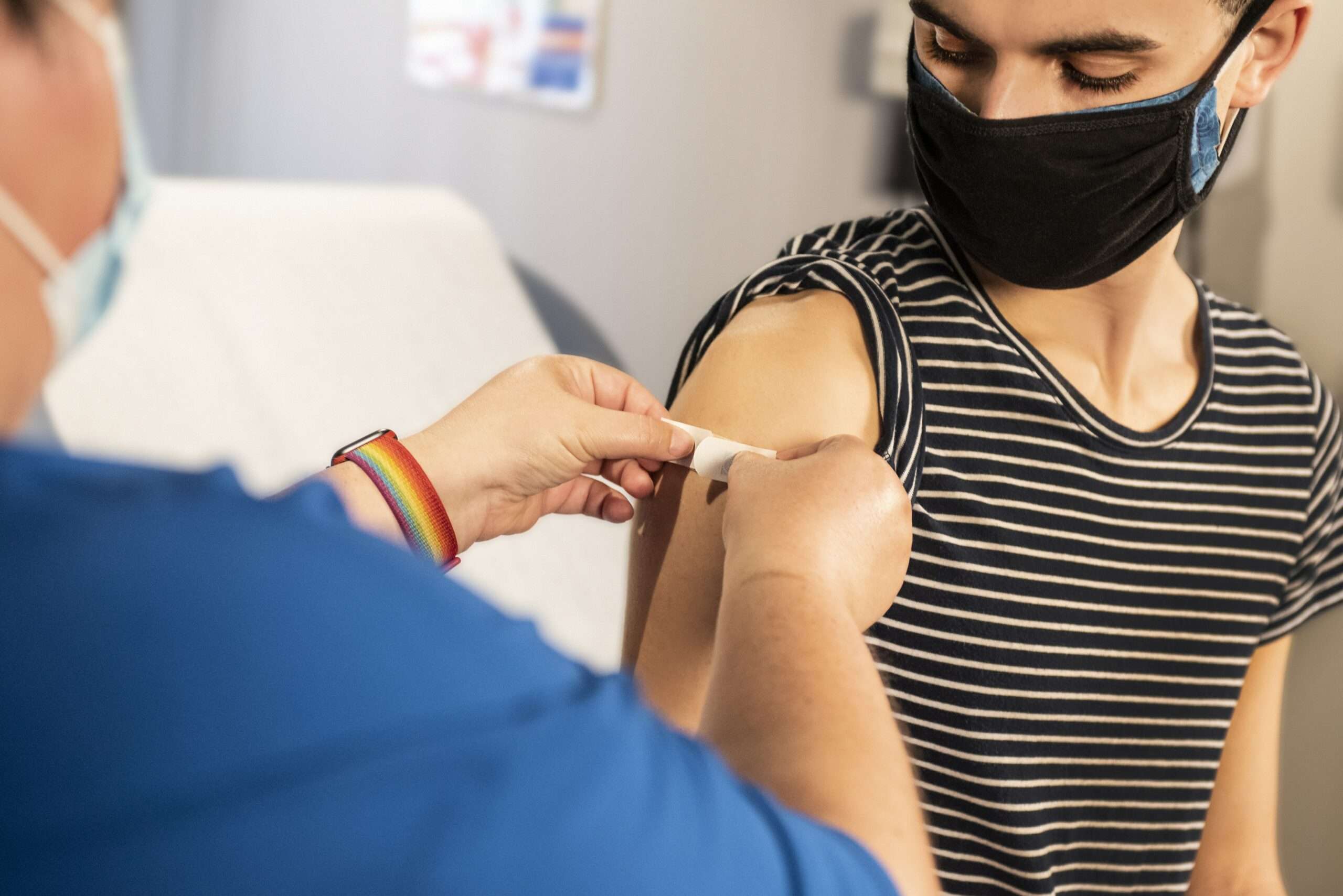 A physician gives an injection to a patient.