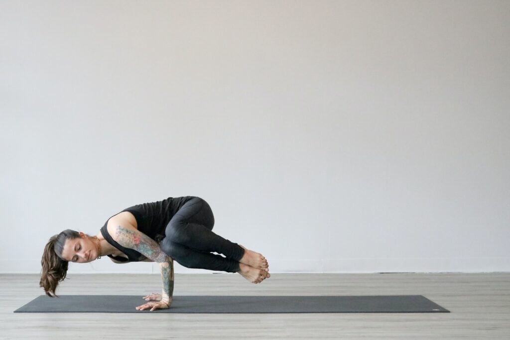 A woman doing a difficult yoga pose.