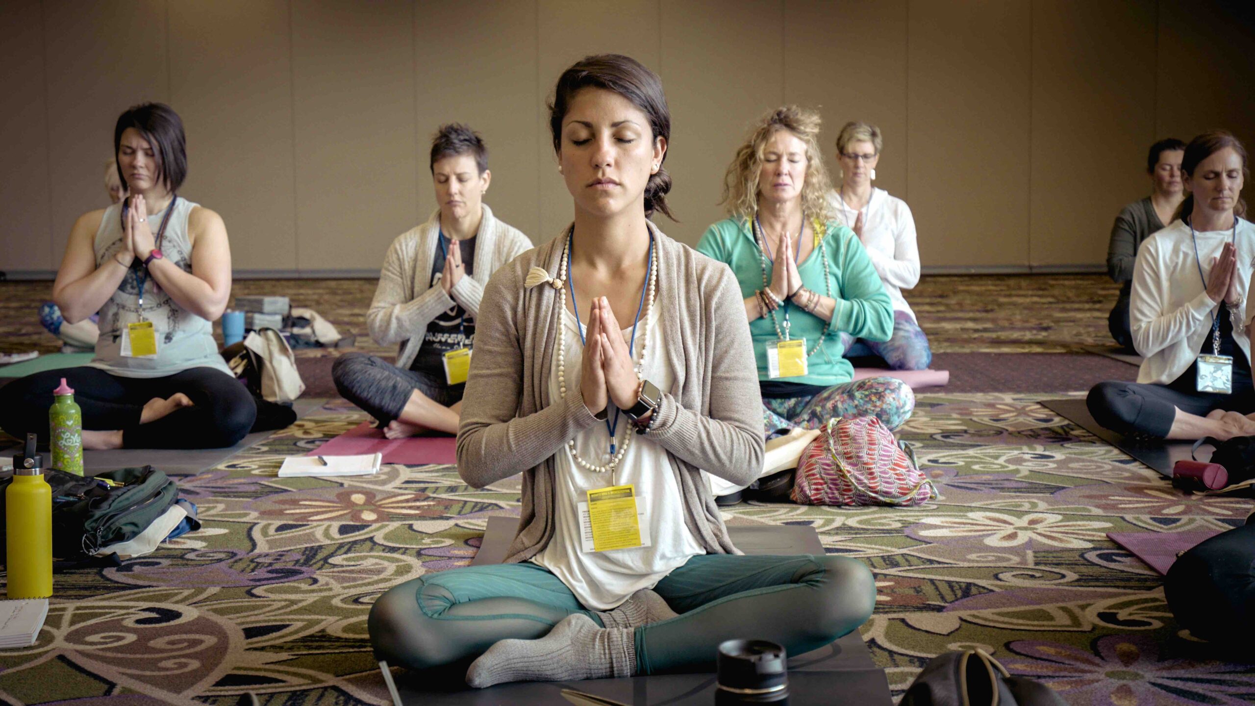 A group of seated participants in one of the guided meditation classes offered at a meditation center.